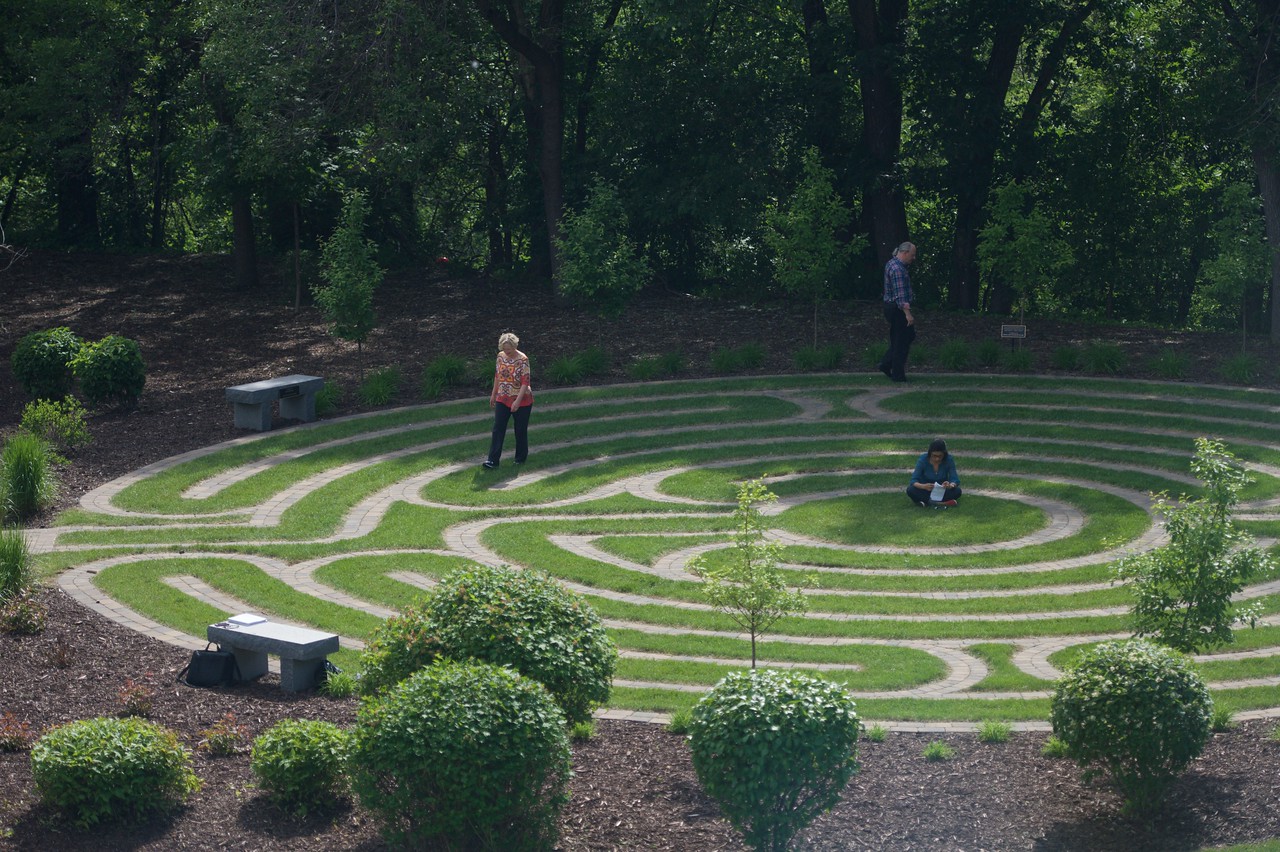 People walking around an outdoor labyrinth