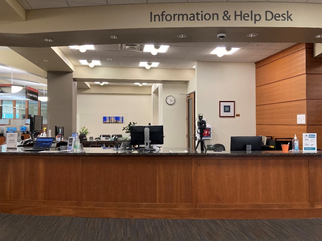 the first floor information commons desk in the library and learning center